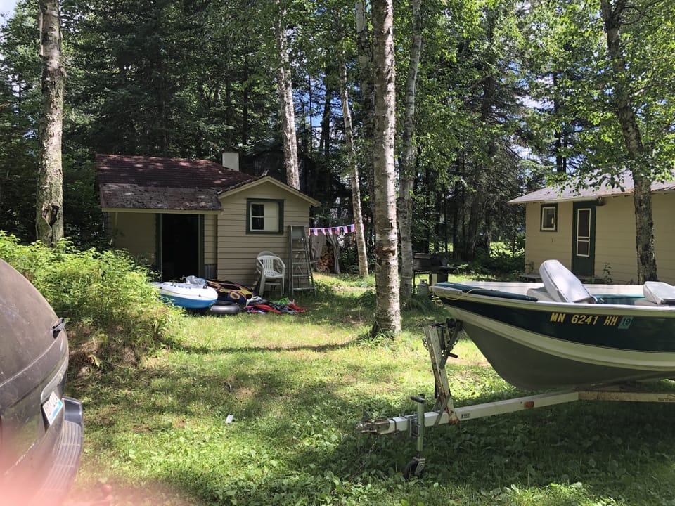 out building behind cabin.   back half storge.  front half is bathroom.