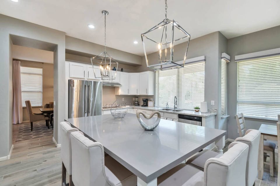 Kitchen features a traditional coffee maker, flat top cook stove, dishwasher, refrigerator