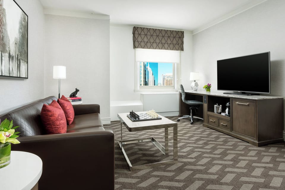 Settle into a bright suite with skyline views and lounge seating.