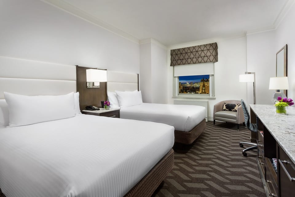 Unwind in crisp twin beds with sparkling skyline views.