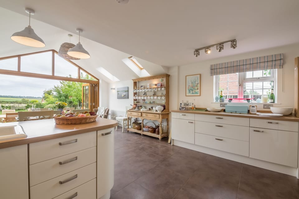 The Potting Shed and Bothy, Ringstead: Spacious kitchen with dining area and bi-fold doors to the garden