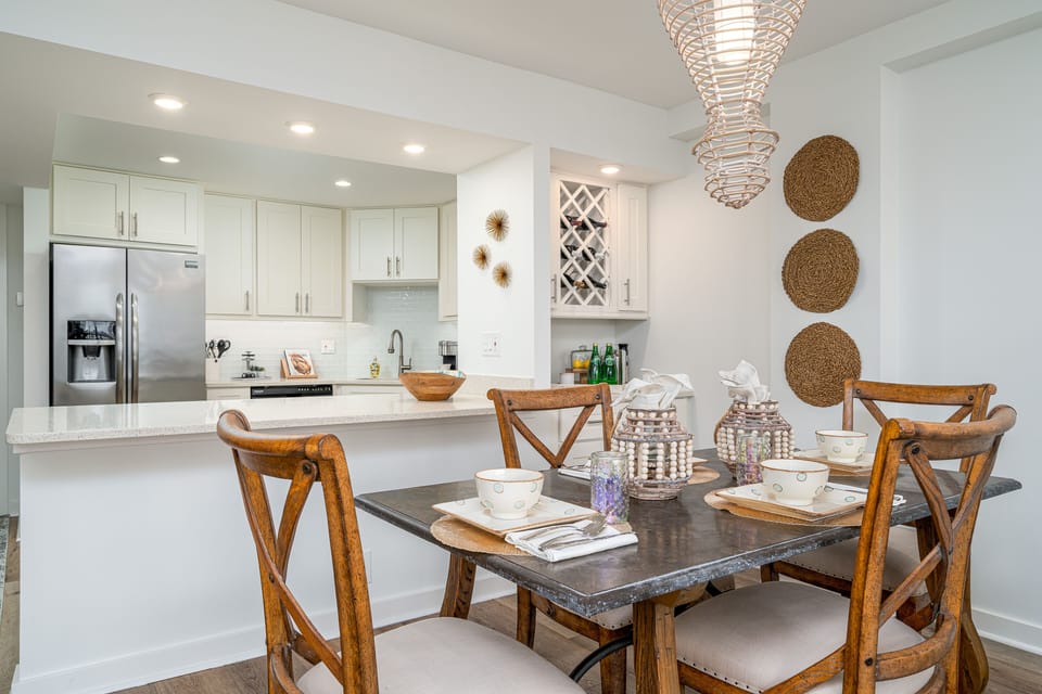Mini bar and open concept to kitchen. Stone dining table.