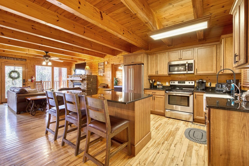 The brand new kitchen features updated stainless steel appliances and custom bar seating.