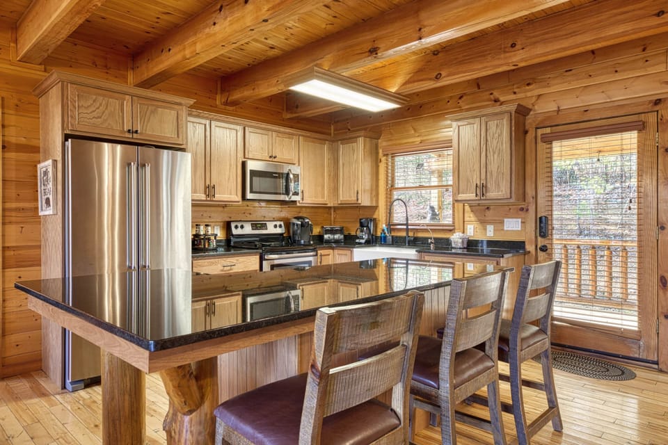 Newly renovated kitchen is outfitted with granite countertops and custom cabinets.