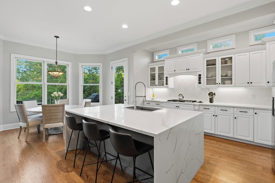 Remodeled kitchen with waterfall island and integrated appliances