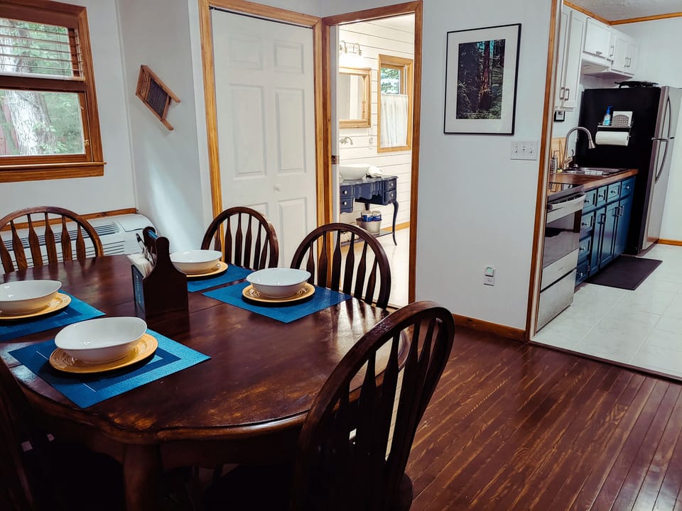 Dining room with view of adjoining laundry room, bathroom and kitchen.