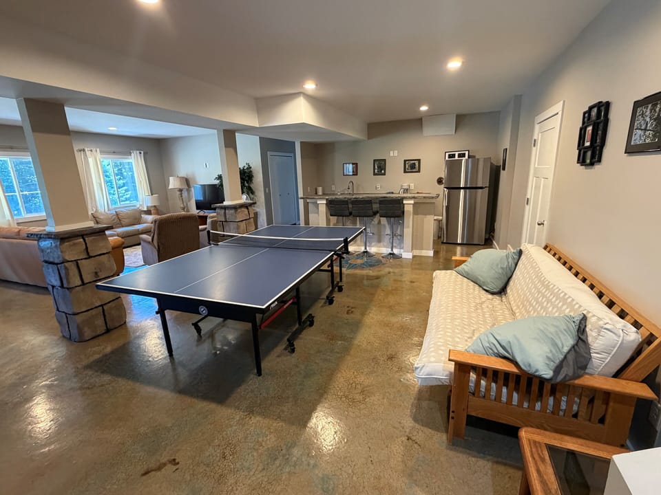 Downstairs open concept living area, with wet bar, ping pong table and walkout.