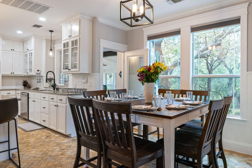 Plenty of natural light in the dining area with 8-seat dining table and bar seating