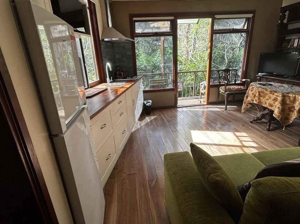 Big glass windows and door (with roll-up shades) open to a beautiful garden. 