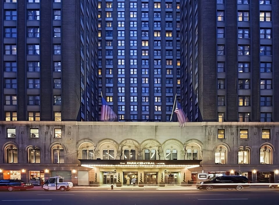Arrive in style beneath glowing lights at the grand entrance