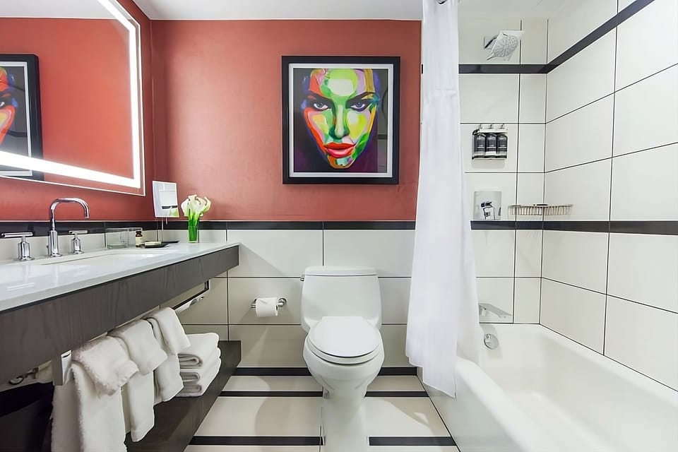 Refresh effortlessly in a sleek bath with bright vanity lighting.