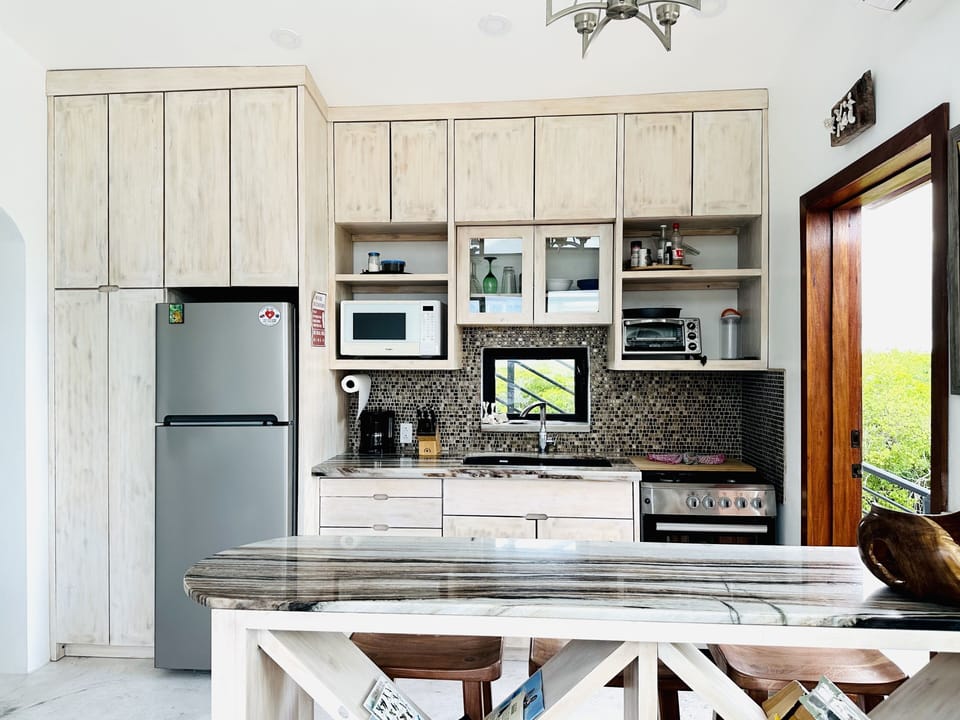 Full kitchen, including gas stove oven, toaster oven, microwave, coffeepot