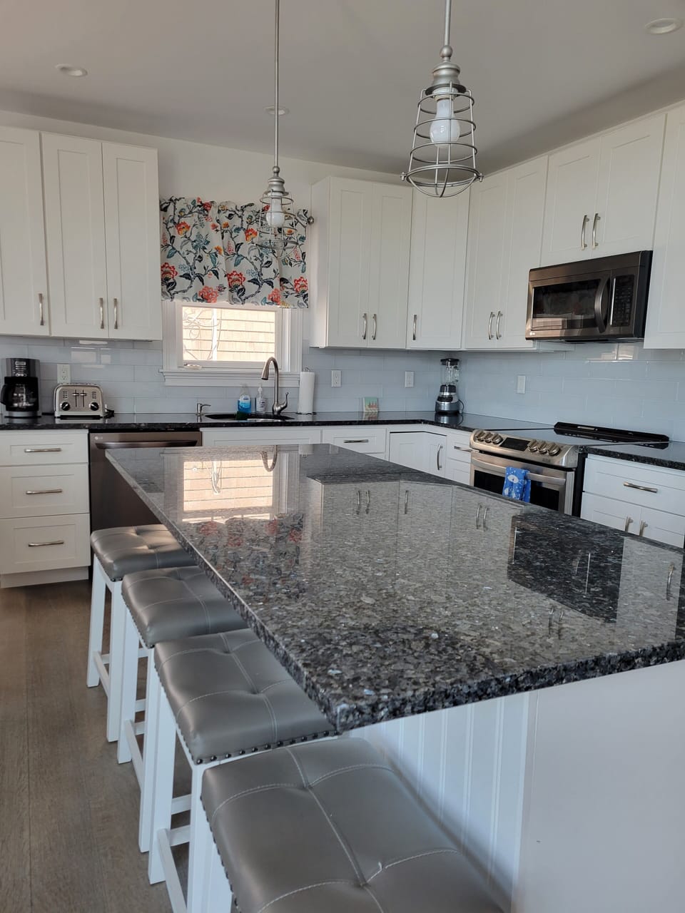 big center island seats 4 comfortably and kitchen is equipped with all you need