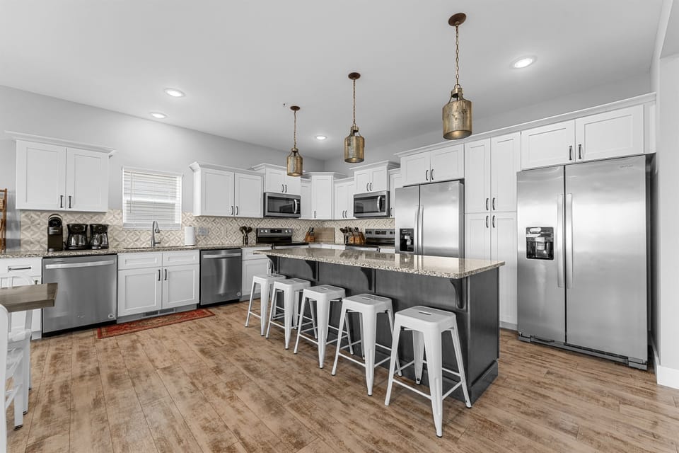 Kitchen with 2 refrigerators, 2 dishwashers, and 2 stoves!