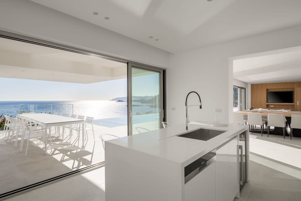 The open plan kitchen-dining area | direct access to terrace.