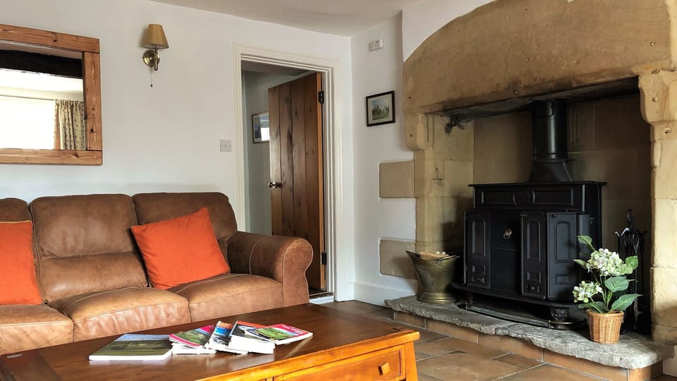 Comfy leather sofa for relaxing in front of fire and TV. 
