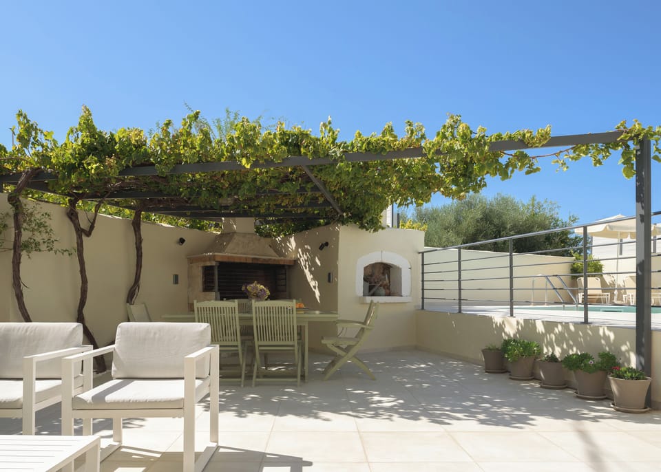 The outdoor dining area is perfect for family meals and gatherings, with a BBQ.