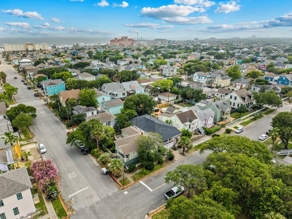 From above — Galveston's Gulf and historic streets frame M Street Double, an easy 8-minute walk to the sand.