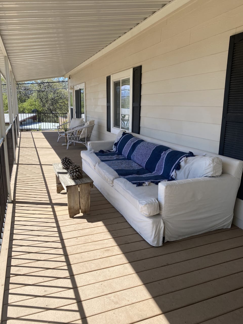 Comfortable couch on veranda overlooking the lake