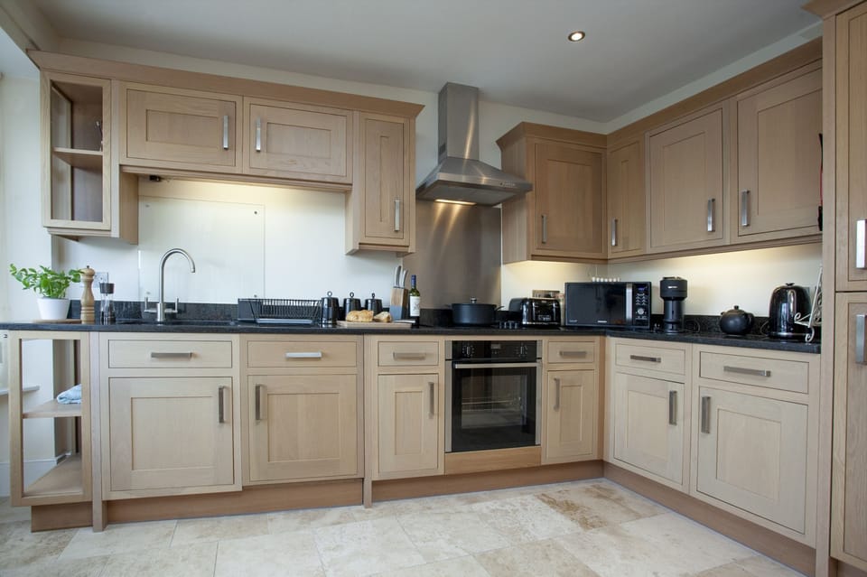 Kitchen with dishwasher, coffee machine, kettle, toaster and microwave - Waterview House