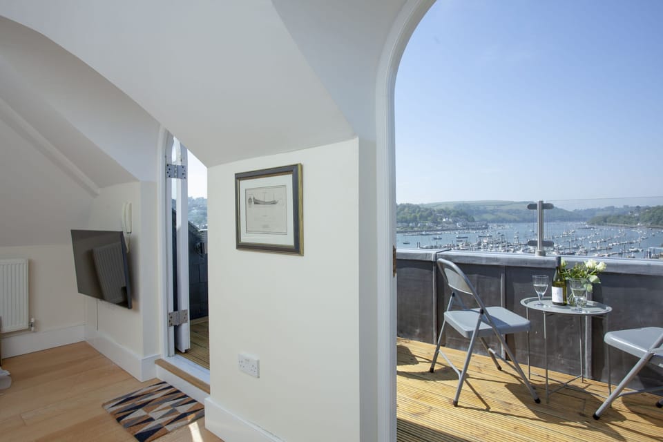 Living room with feature windows and access to the balcony with wonderful river views - Waterview House