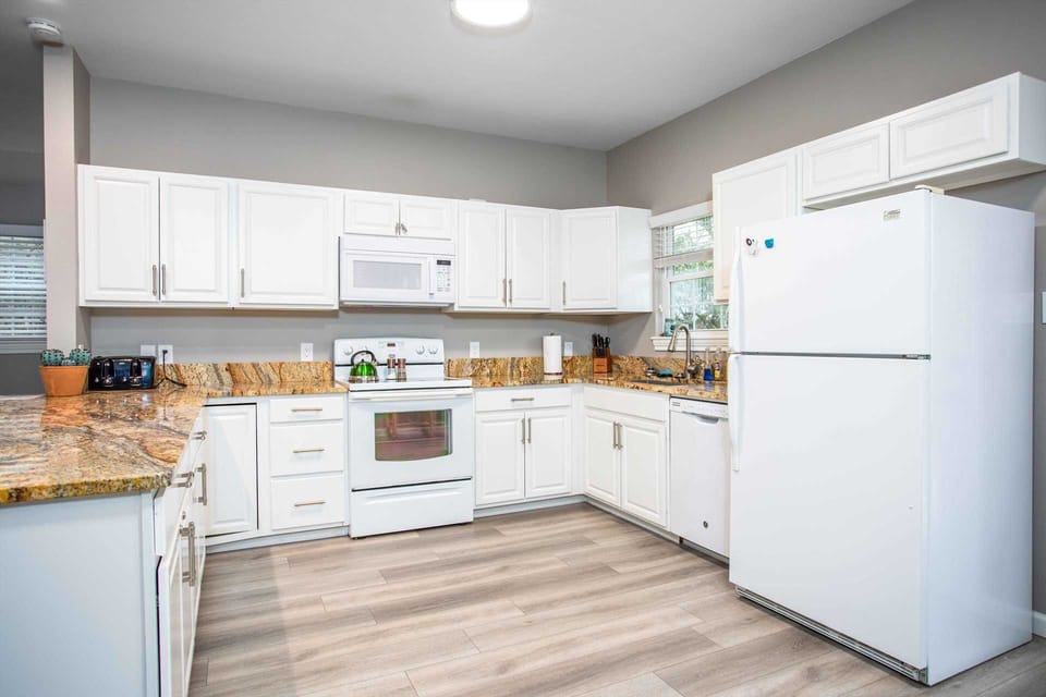 Included in the sharp and modern kitchen are a Keurig coffee maker, and all the cooking ware, serving ware, utensils and glasses you'll need.