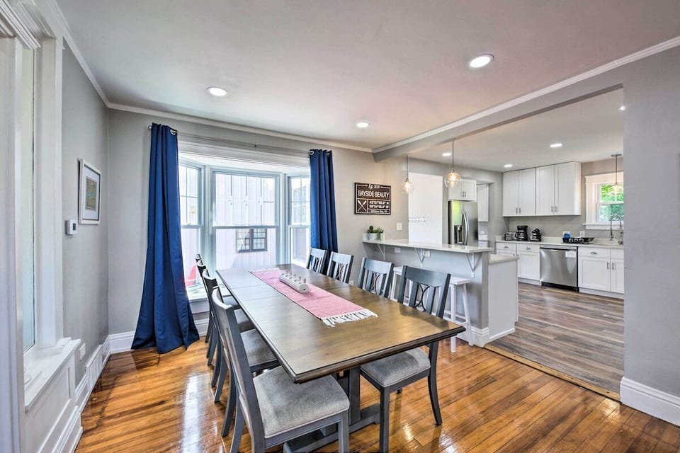 Kitchen table with 8 chairs and a window cushion.