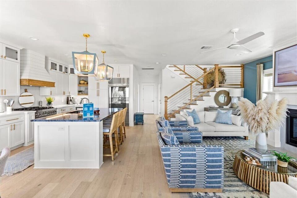 Bright, airy space with modern decor, cozy seating, and chic kitchen views