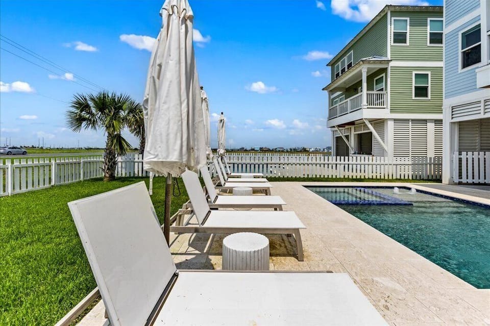Lounge under sun-kissed skies by the inviting pool and palm-filled views!