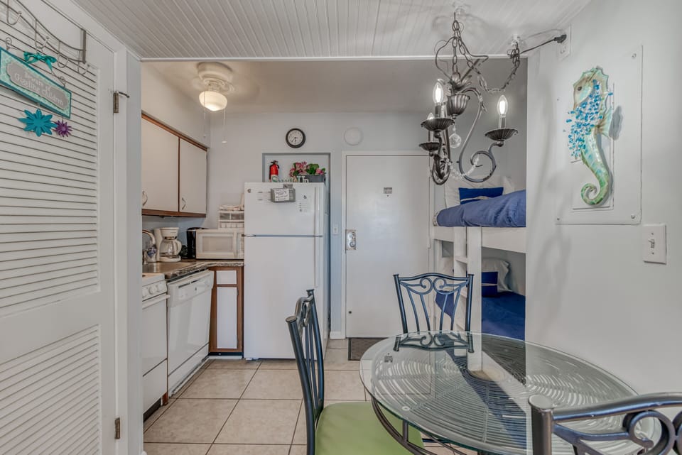 Kitchen/Dining - The kitchen and dining area is compact but offers everything you need for meal prepping. A dining table is provided with seating for 3.