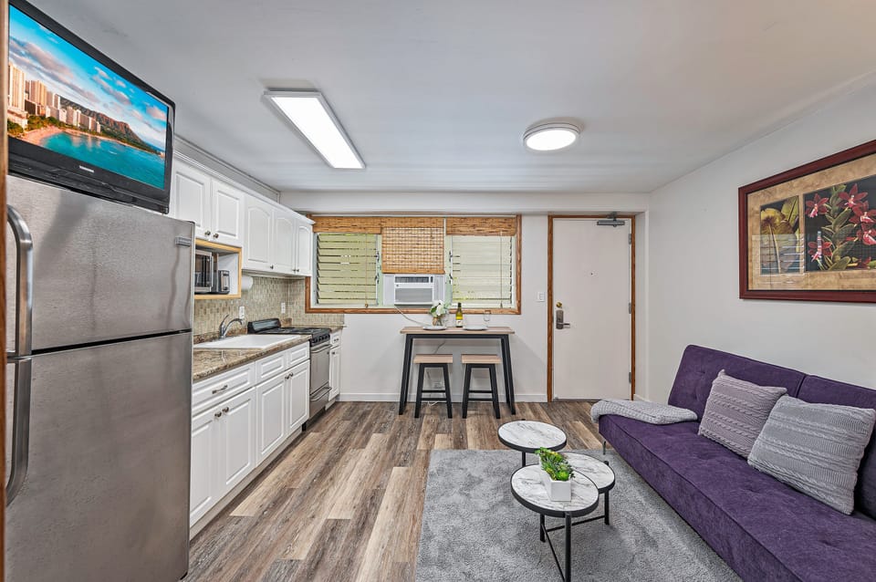 Spacious kitchen and living room with flat screen TV