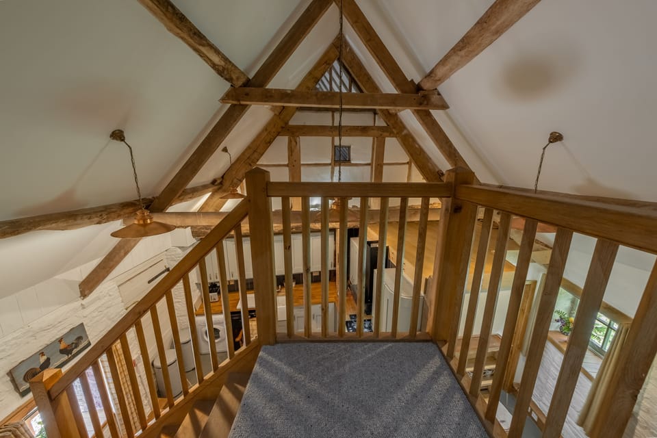 Gallery staircase looking down to ground floor living area