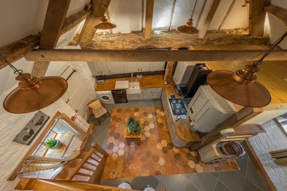 Gallery staircase looking down to ground floor living area