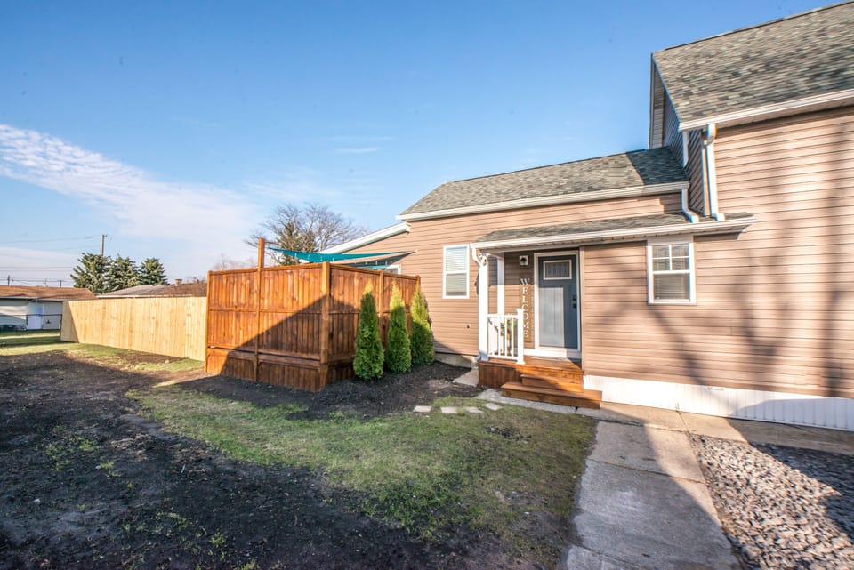 Side Door Entrance & view of fully fenced yard and private deck.
