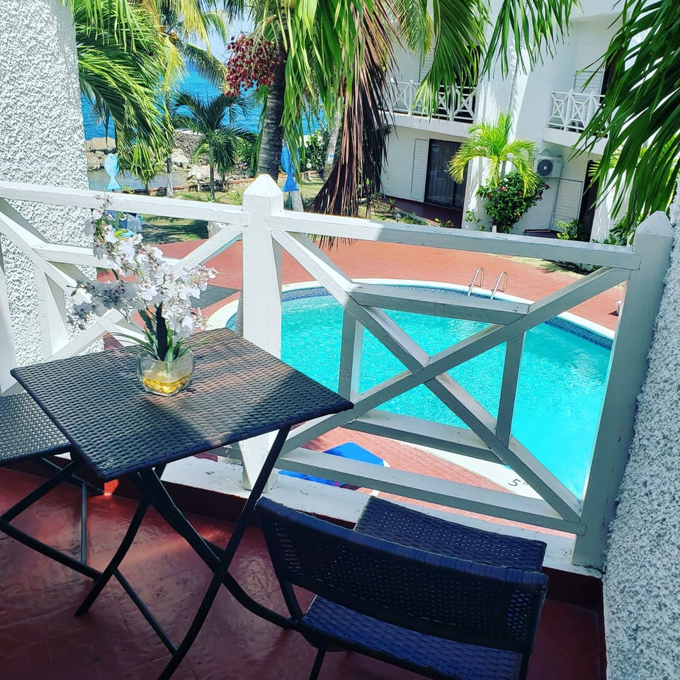 balcony with views or pool and Caribbean sea