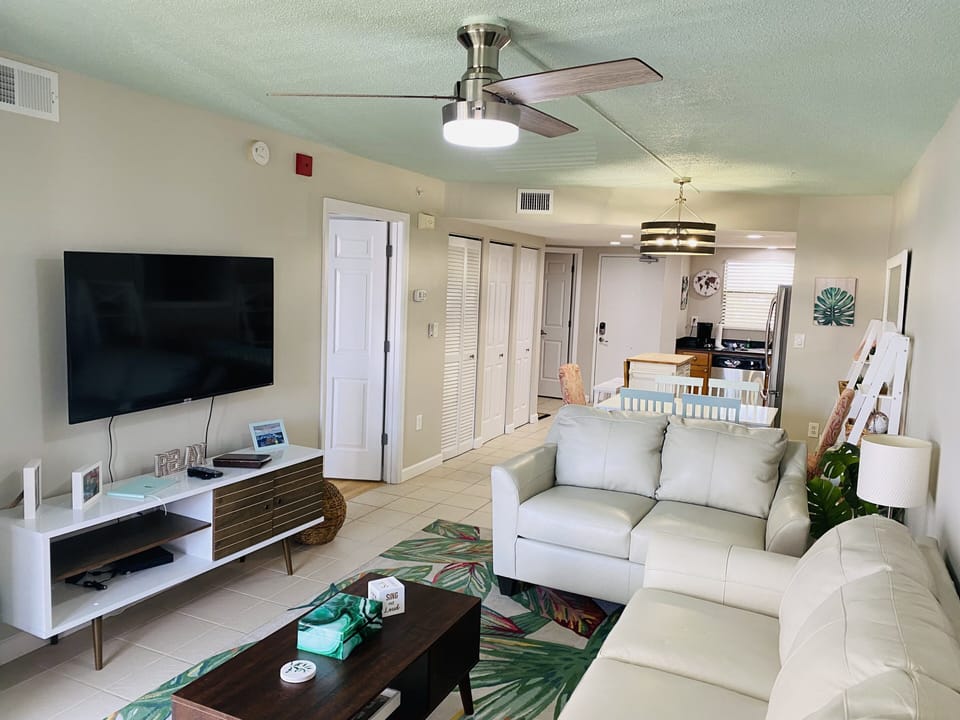Living room. Brand new leather couches w/ a queen sleeper sofa & foam mattress 