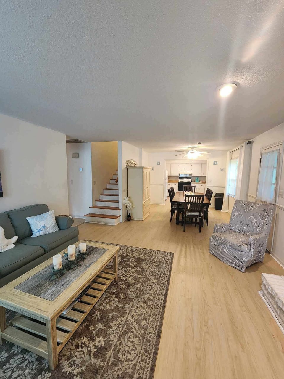 Spacious Ground Floor featuring a seamless flow between the Living Area, Dining Space, and Kitchen. Staircase leads to 2nd-floor bedrooms.