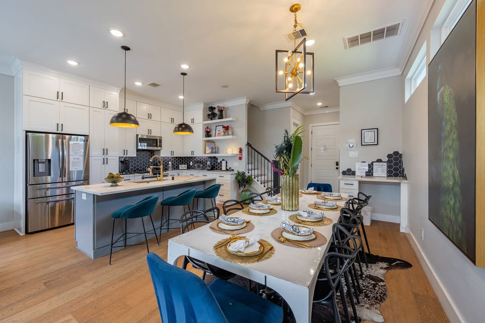 Bright designer kitchen with large island and dining for a crowd