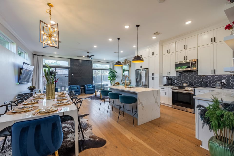 Bright open-concept kitchen, dining & lounge with chic modern finishes