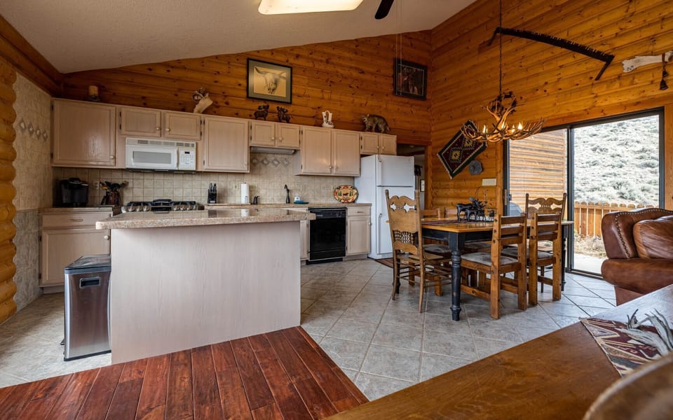 The dining area has access to the patio space with gas grill and outdoor seating for meals al fresco