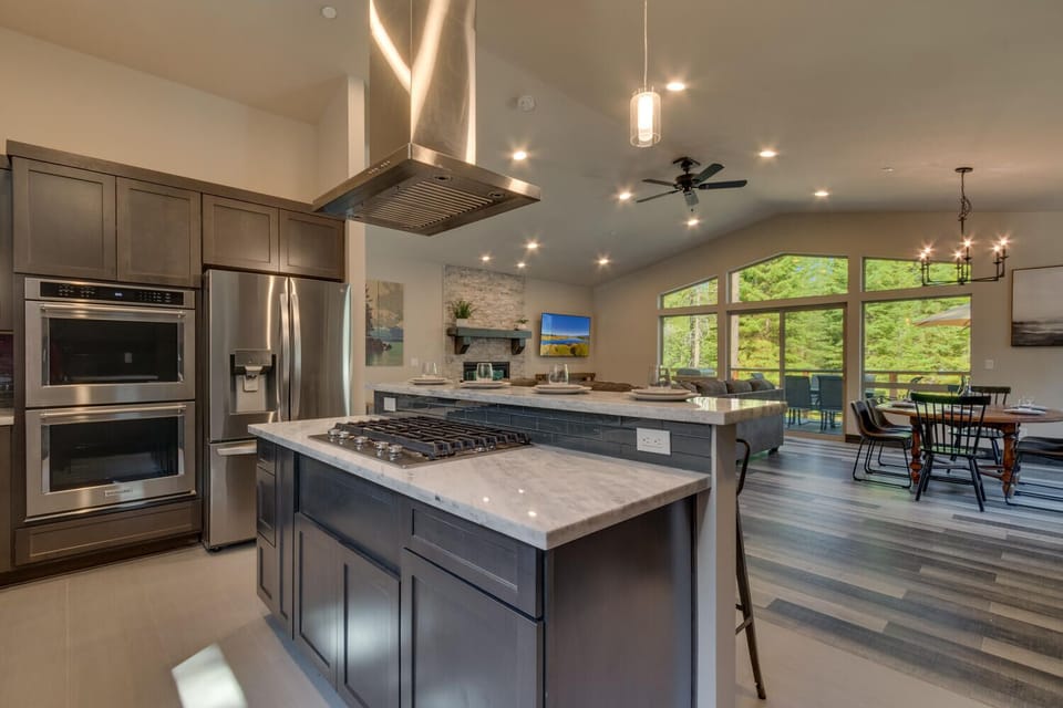- Modern kitchen with island breakfast bar  
- Stainless steel appliances and double oven  
- Perfect for family cooking cabin stays