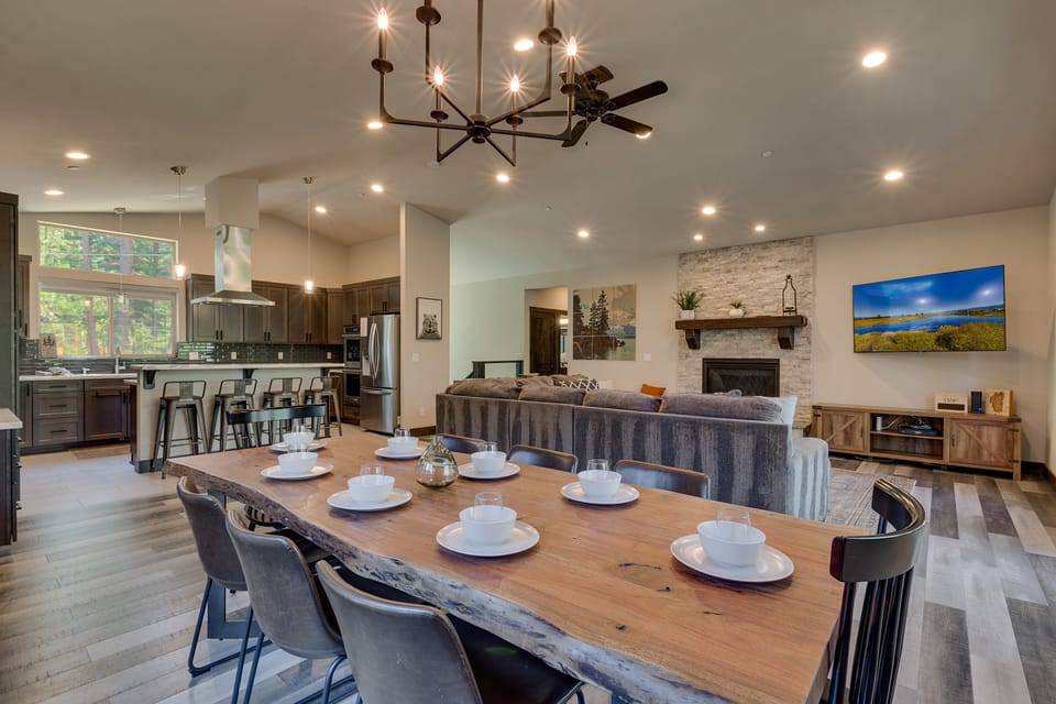 - Large dining table for group meals  
- Stone fireplace and mounted TV feature  
- Open concept lodge near Lake Tahoe