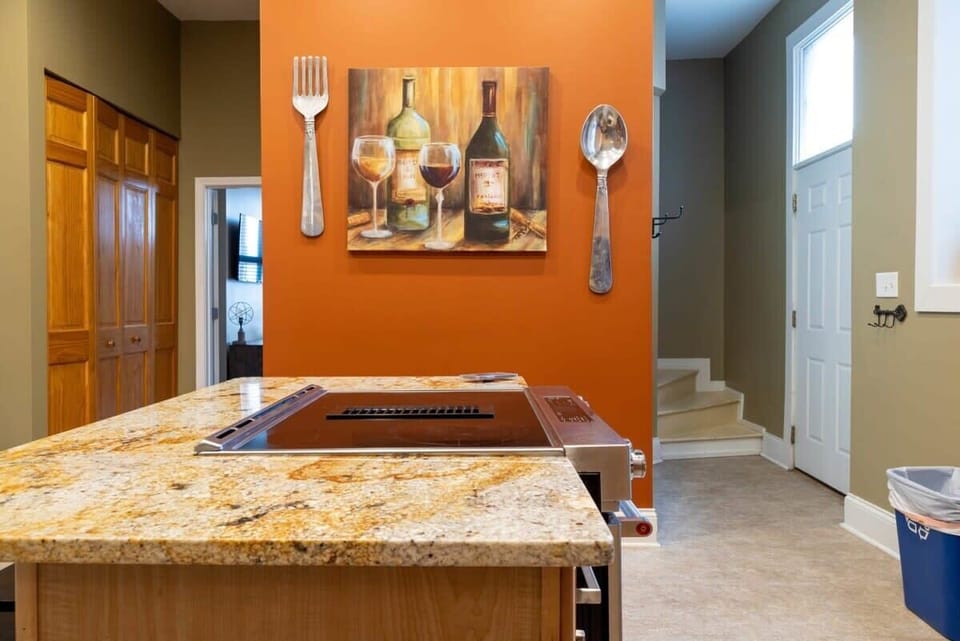 Spacious kitchen island with built-in cooktop, perfect for preparing meals and gathering together. #CookAndStay