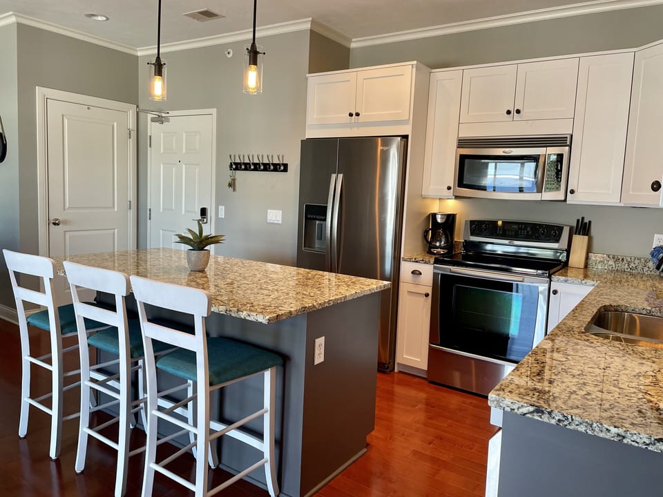 Updated kitchen with island seating. Fully stocked for all your cooking needs.