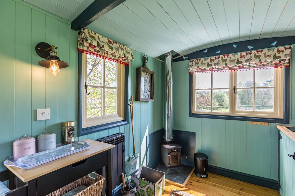 Small log burner and electric wall mounted heater.