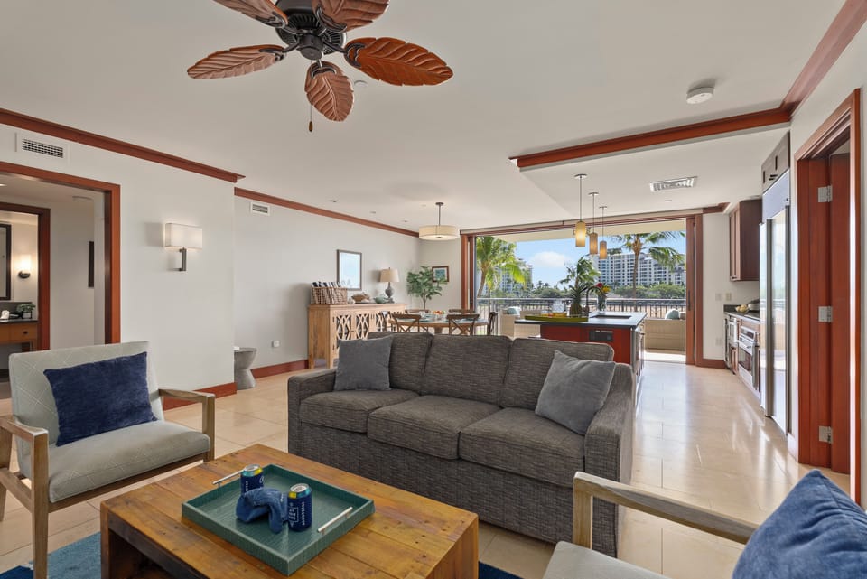 Bright and comfortable living space with modern furnishings, a sleeper sofa and island-inspired decor.