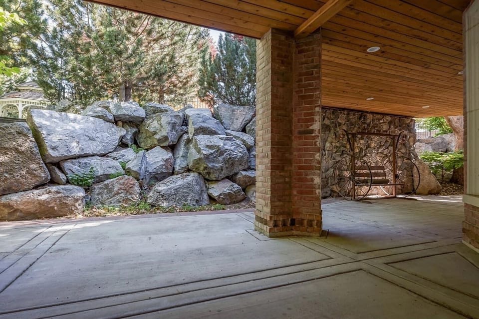  Lower Level Patio with gas fireplace, ole antique pioneer wheel swing with chairs & table for relaxing.