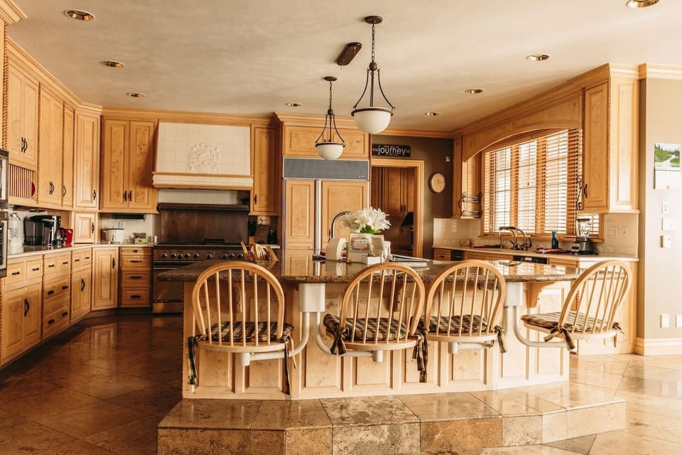 Main Kitchen has a large island with 8 swivel chairs, 4 sinks, 3 disposals, 2 dishwashers, 2 microwaves, 2 ovens 8 cook top burners, and a subzero fridge