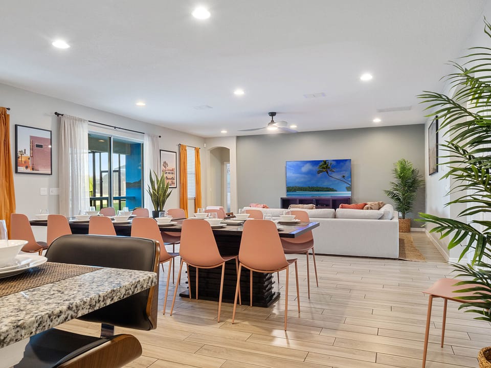 - Spacious dining area with seating for large groups  
- Open living room with smart TV and bright accents  
- Perfect Orlando vacation rental for family gatherings