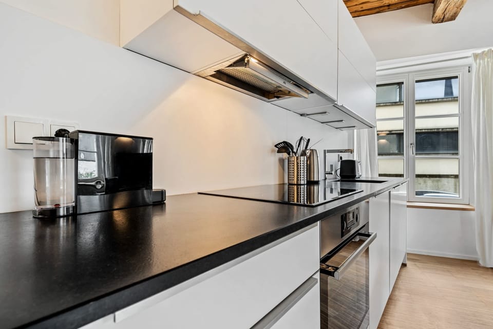 Sleek kitchen countertop with modern appliances, perfect for preparing meals during your stay.
